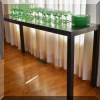 F32. Founders black console table. 28”h x 60”w x 17.5”d 